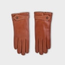 Handcrafted from smooth caramel lambskin and lined with natural beige cashmere. Finished with a decorative, hand-stitched leather strap in contrasting beige thread. Featuring the signature brass logo closure in silver, nickel-free and protected with a durable, polished finish. Made in an artisanal workshop in Italy. Available in sizes 7, 7.5, 8, 8.5, 9, 9.5 (Italian sizing).