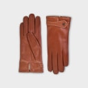 Handcrafted from smooth caramel lambskin and lined with natural beige cashmere. Finished with a decorative, hand-stitched leather strap in contrasting beige thread. Featuring the signature brass logo closure in silver, nickel-free and protected with a durable, polished finish. Made in an artisanal workshop in Italy. Available in sizes 7, 7.5, 8, 8.5, 9, 9.5 (Italian sizing).