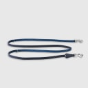 Hand-stitched from grained, cactus vegan leather in an artisan workshop in the EU. Characterized by Pattmond’s signature shape, distinguished by subtle shifts in width and refined ornamental details. Navy cactus-based leather with matching navy stitching. Solid brass hardware in silver (signature snap hook and logo studs), nickel-free and protected with a durable, polished finish. Adjustable length of 230 cm, 150 cm, and 115 cm. With a width of 2.2 cm, it is proportioned for larger dogs.