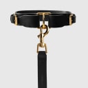 A dog collar in natural bovine leather, hand-sewn in a Polish artisan workshop. Raw edges and clean lines bring out the natural character of vegetable-tanned leather. The collar is defined by its solid brass hardware, nickel-free and made to order for Pattmond by an Italian manufacturer. The polished gold finish gives it a jewellery-like quality. A distinctive metal piece at the centre of the collar makes clipping on the leash easy, and two side buckles with the Pattmond logo allow a precise fit. Available on its own or as a set with the matching leather leash.