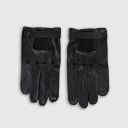 Gloves in natural black lambskin, made in an Italian artisan workshop. Designed by the Italian designer Francesco Rigucci. Entirely hand-sewn from smooth lambskin, prized for its exceptional softness. They are unlined, which makes them just as wearable on milder days. The cut-out at the wrist gives them their modern shape. The signature solid brass fastening comes in gunmetal finish, nickel-free and protected with a durable polished coating. Available in sizes 7, 7.5, 8, 8.5, 9 and 9.5 (the size matches the hand circumference in inches).