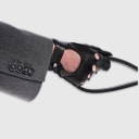 Gloves in natural black lambskin, made in an Italian artisan workshop. Designed by the Italian designer Francesco Rigucci. Entirely hand-sewn from smooth lambskin, prized for its exceptional softness. They are unlined, which makes them just as wearable on milder days. The cut-out at the wrist gives them their modern shape. The signature solid brass fastening comes in gunmetal finish, nickel-free and protected with a durable polished coating. Available in sizes 7, 7.5, 8, 8.5, 9 and 9.5 (the size matches the hand circumference in inches).